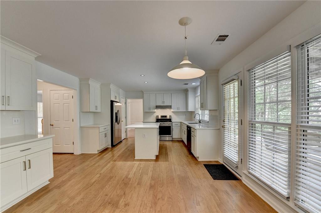 6535 Ganton Drive Duluth, GA 30097 - Photo 32 of 75 a kitchen that has a lot of cabinets a sink and appliances in it