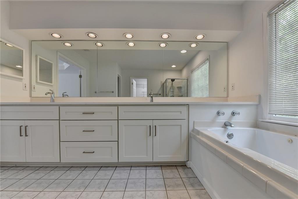 6535 Ganton Drive Duluth, GA 30097 - Photo 55 of 75 a spacious bathroom with a granite countertop sink mirror and bathtub