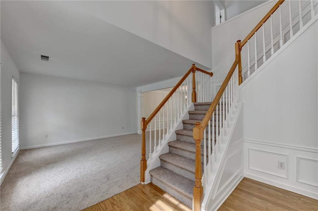 6535 Ganton Drive Duluth, GA 30097 - Photo 6 of 75 a view of staircase with wooden floor and white walls