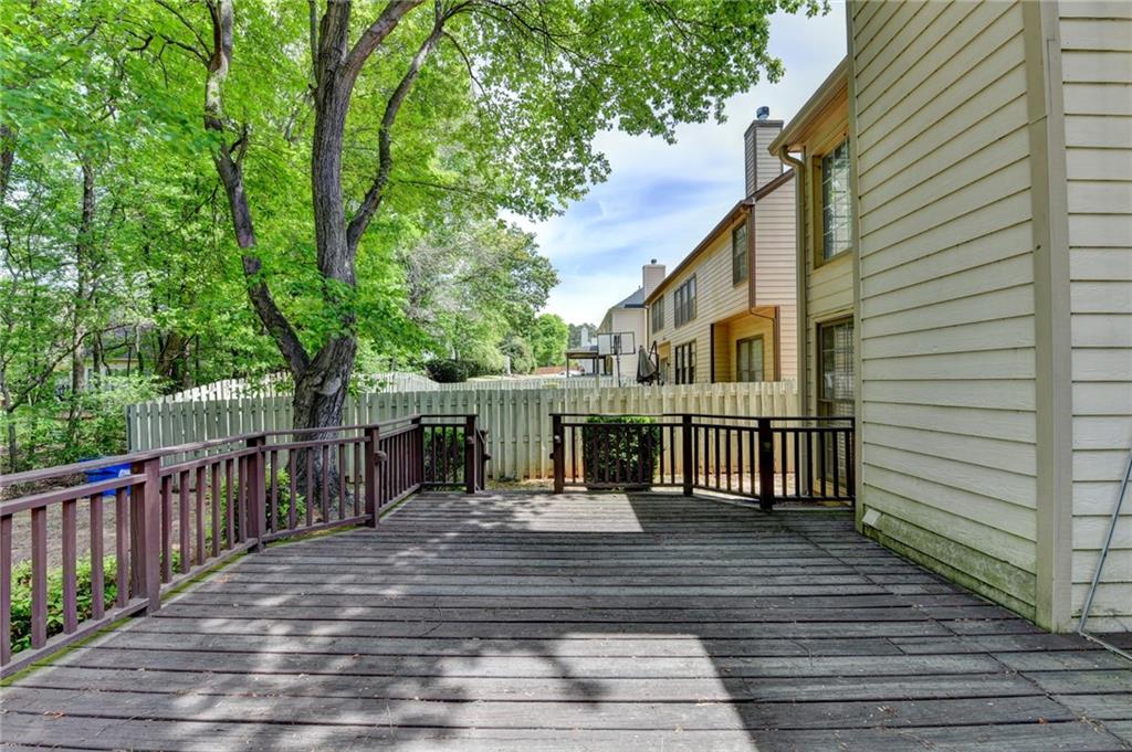 6535 Ganton Drive Duluth, GA 30097 - Photo 70 of 75 a view of a deck with wooden floor and fence next to a yard