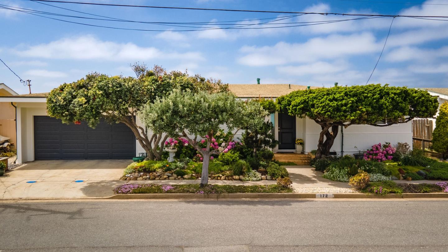 172 Shoreview Avenue Pacifica, CA 94044 - Photo 2 of 38 a front view of a house with a yard and a garage