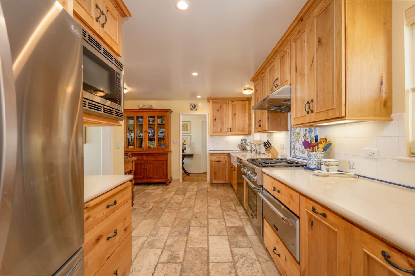 172 Shoreview Avenue Pacifica, CA 94044 - Photo 25 of 38 a kitchen with stainless steel appliances granite countertop a refrigerator a sink and white cabinets