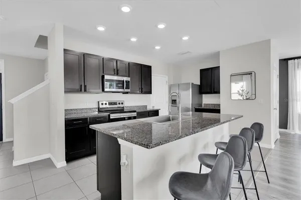 a kitchen with stainless steel appliances granite countertop a stove and a sink
