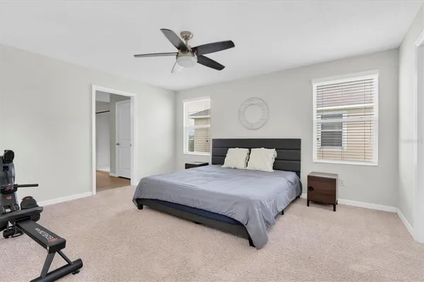 a bed room with a bed and a ceiling fan