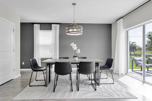 a view of a dining room with furniture wooden floor and chandelier