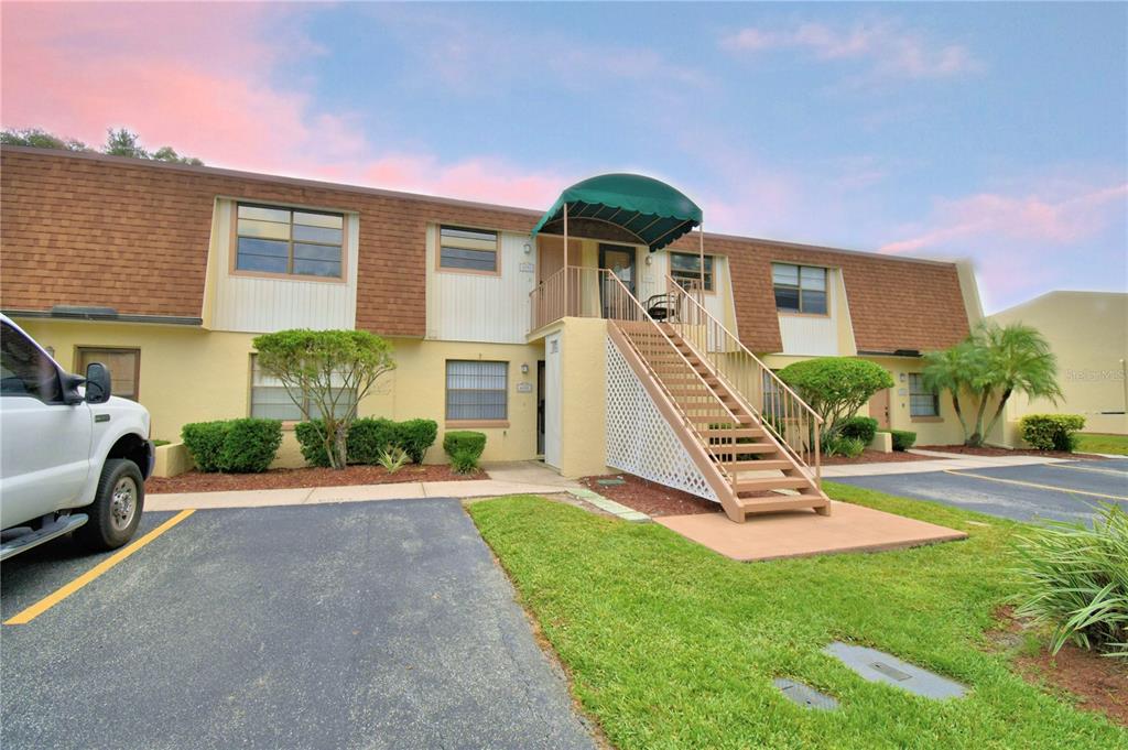 a view of a house with a yard patio and a slide