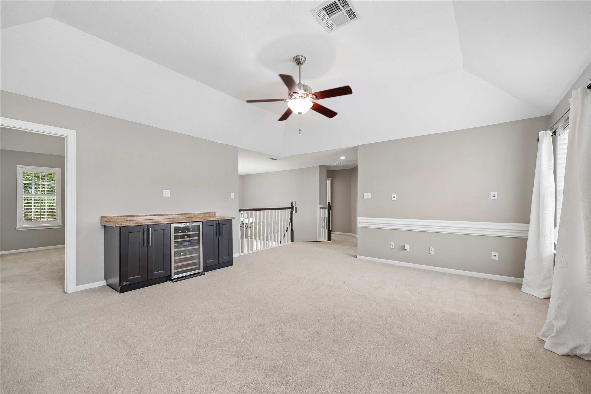 7915 Huddersfield Court Spring, TX 77379 - Photo 25 of 37 The second-floor game room includes a built-in bar area with wine fridge, vaulted ceiling, and easy access to nearby secondary bedrooms.