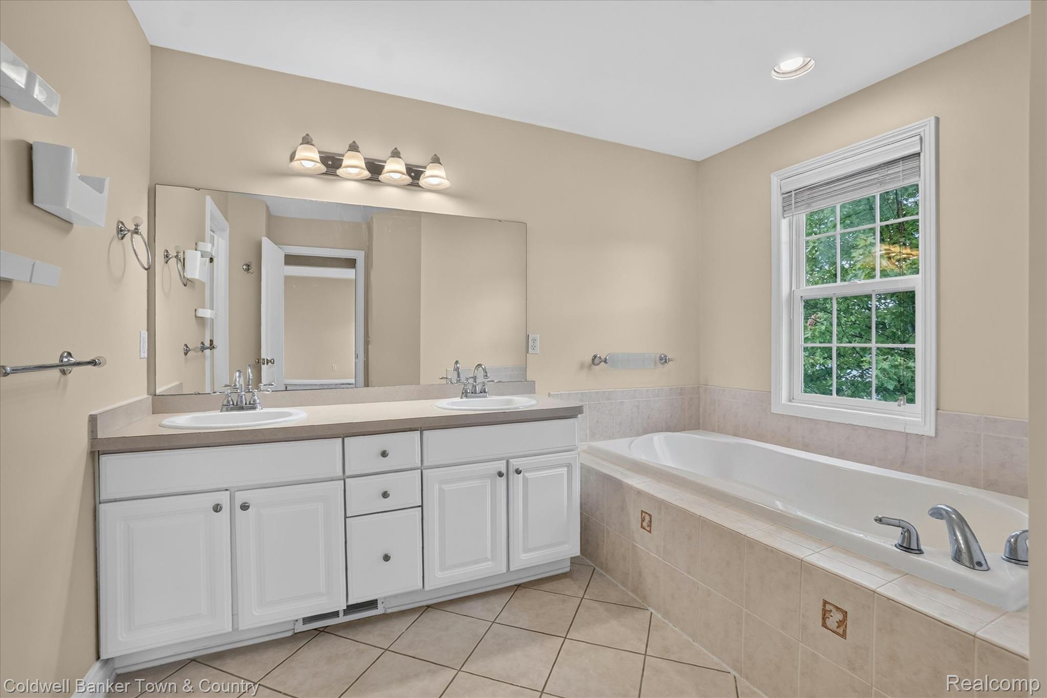 1725 Town Commons Drive Howell, MI 48855 - Photo 34 of 53 Bathroom featuring a dual vanity with white cabinetry and a large mirror