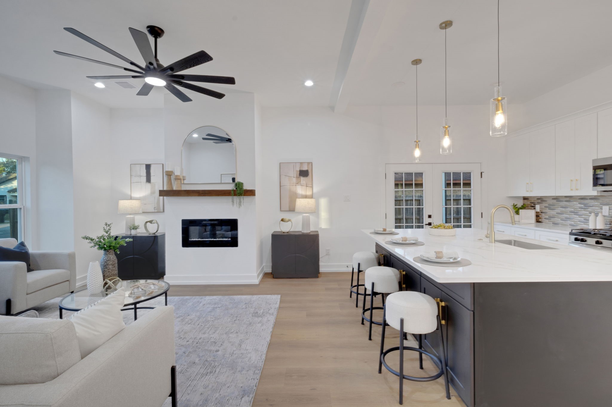 4202 Plaag Street Houston, TX 77016 - Photo 12 of 38 Bright and airy living space with open-concept design, modern ceiling fan, and seamless flow into the kitchen.