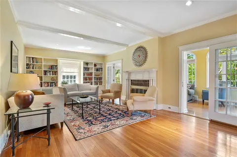 a living room with furniture and wooden floor