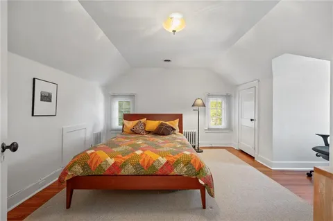 a bedroom with a bed and window