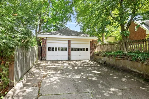 a view of a house with a tree in front