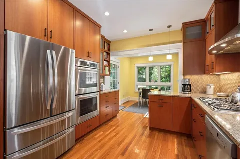 a kitchen with stainless steel appliances a refrigerator and a stove top oven