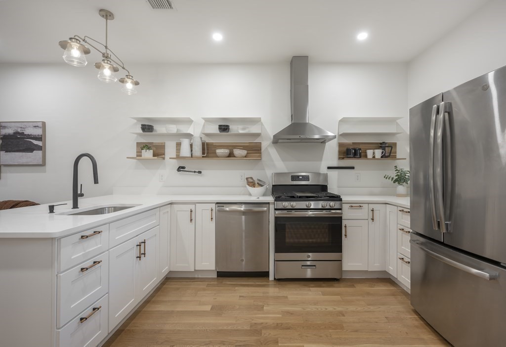 43 Wordsworth Street, Unit 2 Boston, MA 02128 - Photo 3 of 13 a kitchen with stainless steel appliances a sink cabinets and a refrigerator