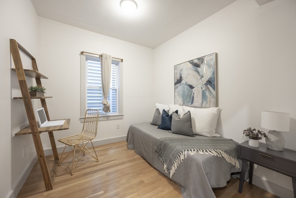 43 Wordsworth Street, Unit 2 Boston, MA 02128 - Photo 6 of 13 a bedroom with a bed and wooden floor