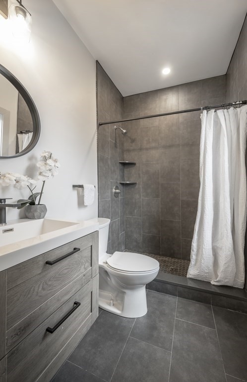 43 Wordsworth Street, Unit 2 Boston, MA 02128 - Photo 8 of 13 a bathroom with a sink a toilet a mirror and shower