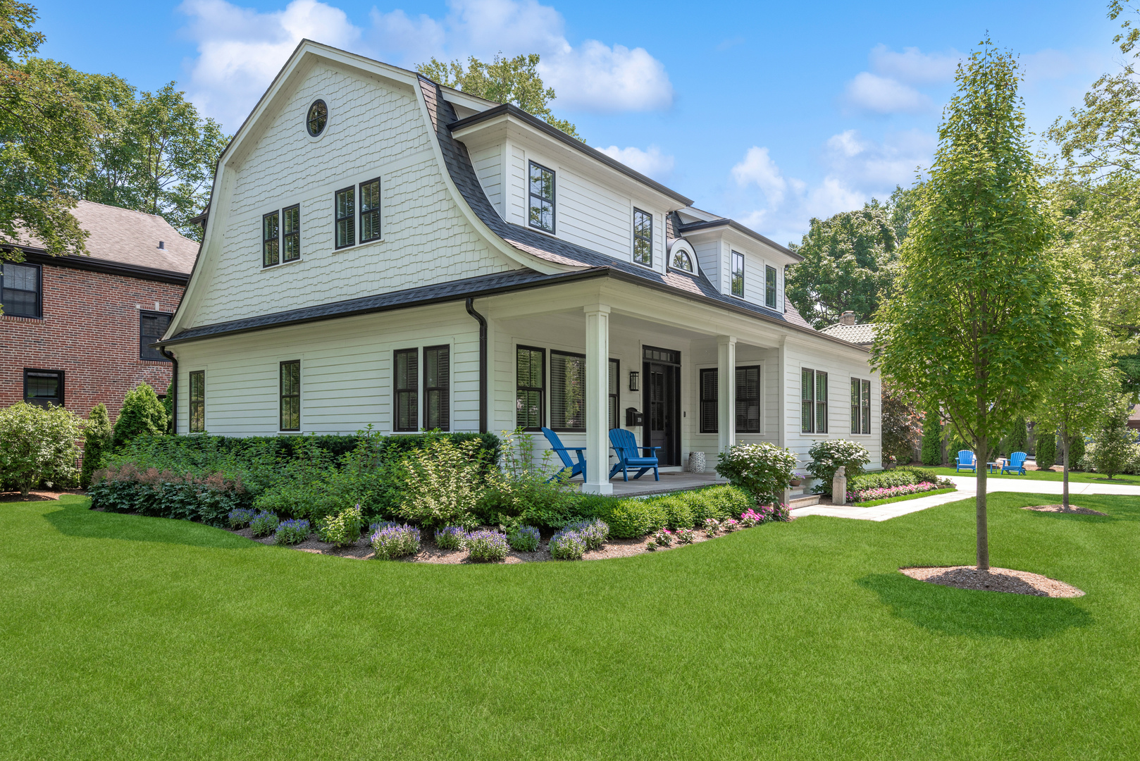 a front view of a house with a yard and trees
