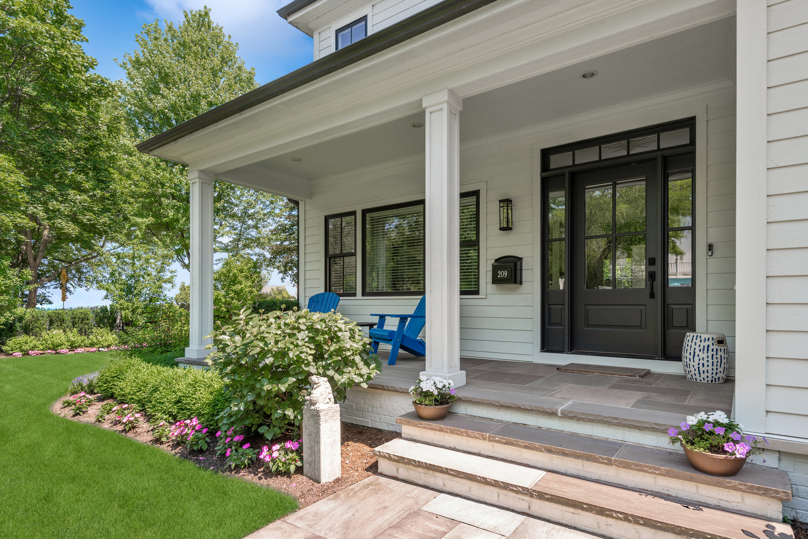 209 Fuller Lane Winnetka, IL 60093 - Photo 4 of 9 a front view of a house with a garden