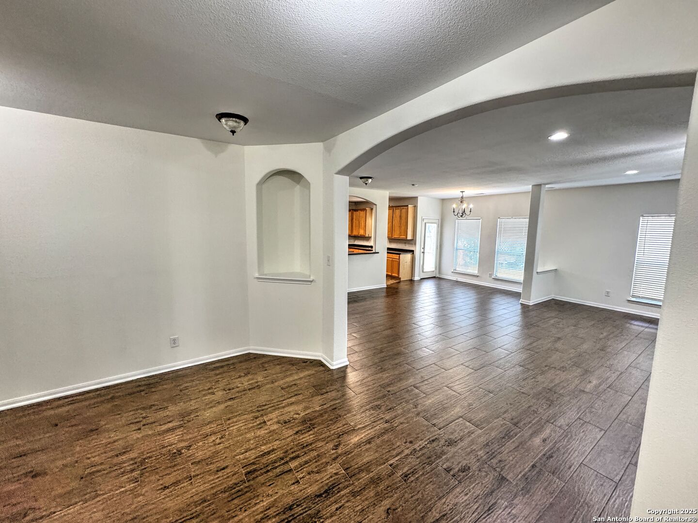 8711 Sandia Circle Helotes, TX 78023 - Photo 18 of 40 a view of an empty room with wooden floor and a window