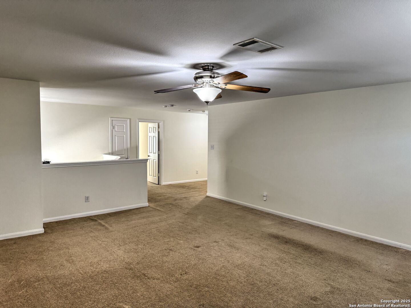 8711 Sandia Circle Helotes, TX 78023 - Photo 30 of 40 an empty room with a window and a ceiling fan