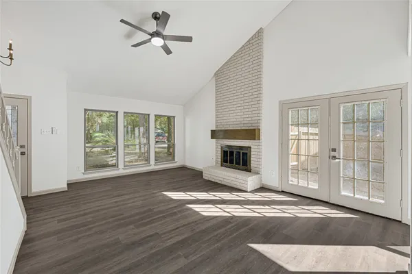 a view of empty room with fireplace and wooden floor