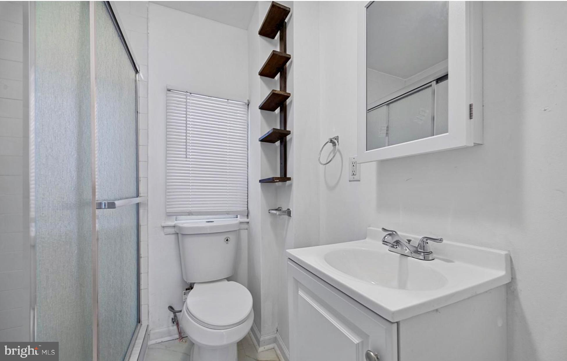 3800 Spring Garden Street, Unit 1 Philadelphia, PA 19104 - Photo 6 of 10 a bathroom with a sink a toilet and shower