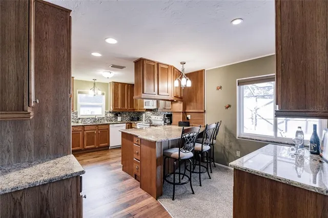 a kitchen with counter top space a sink appliances and cabinets