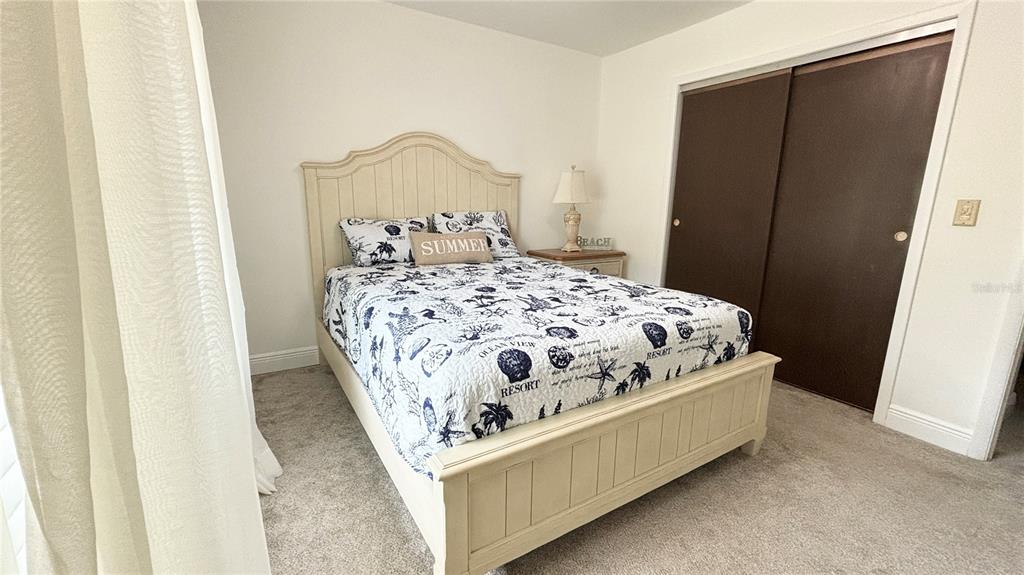 912 72nd Street Northwest Bradenton, FL 34209 - Photo 17 of 25 a bedroom with a bed and a mirror