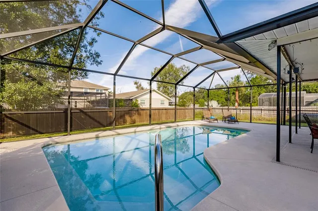 a view of a swimming pool with a lounge chair