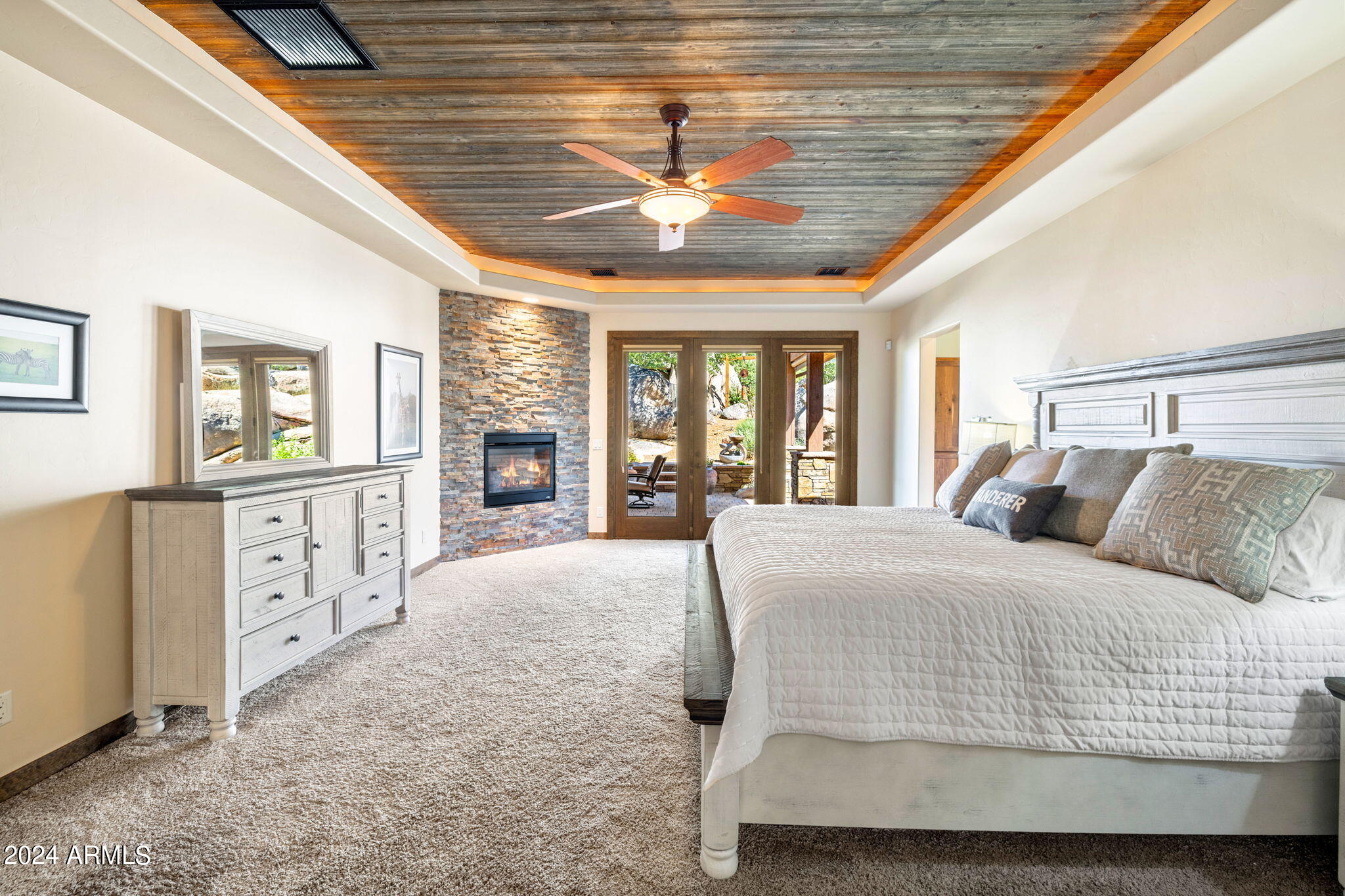 1398 Ridgewood Drive Prescott, AZ 86305 - Photo 16 of 34 a spacious bedroom with a large bed and a chandelier