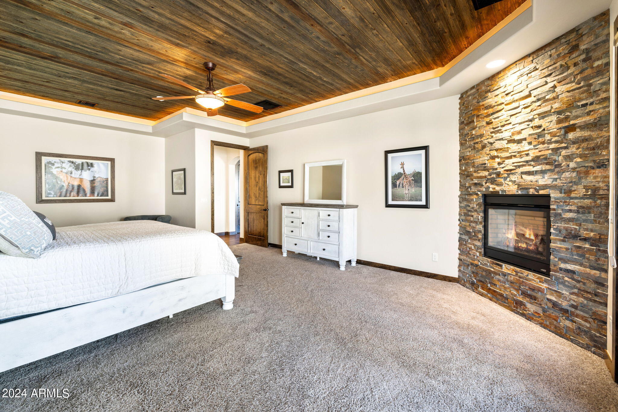 1398 Ridgewood Drive Prescott, AZ 86305 - Photo 17 of 34 a spacious bedroom with a bed and a fireplace