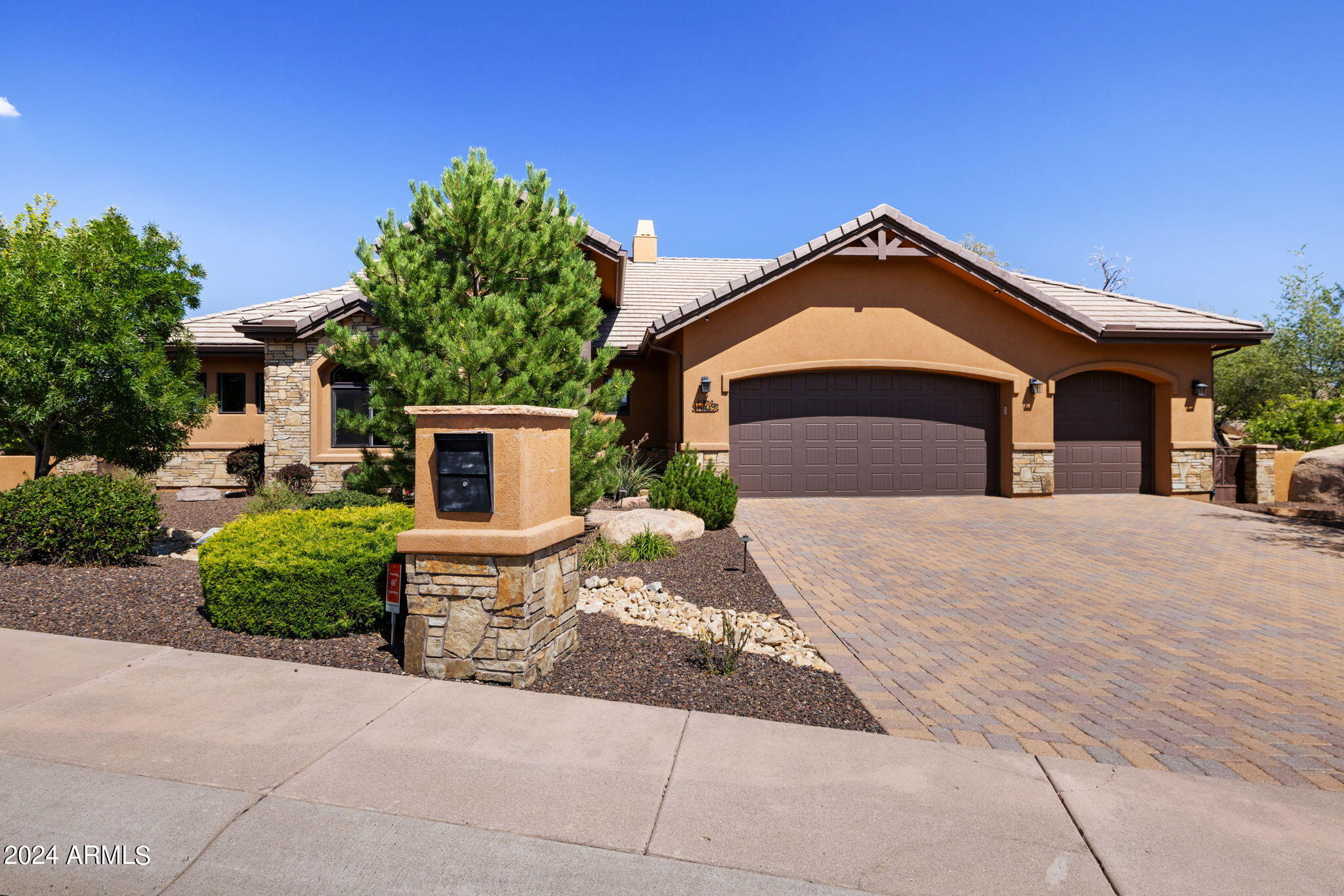 1398 Ridgewood Drive Prescott, AZ 86305 - Photo 3 of 34 a front view of a house with a yard and garage