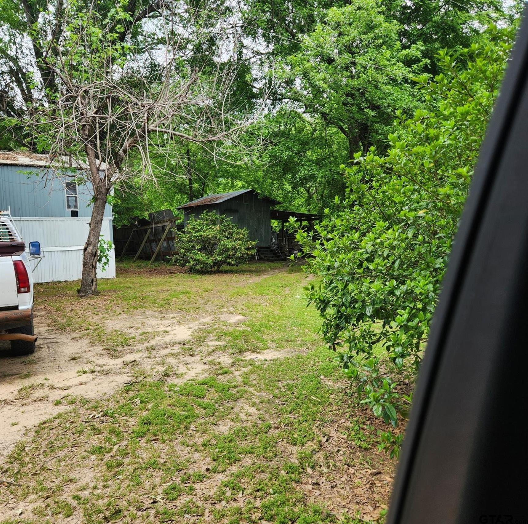 109 Falcon Spur Carthage, TX 75633 - Photo 4 of 13 a view of a backyard of the house