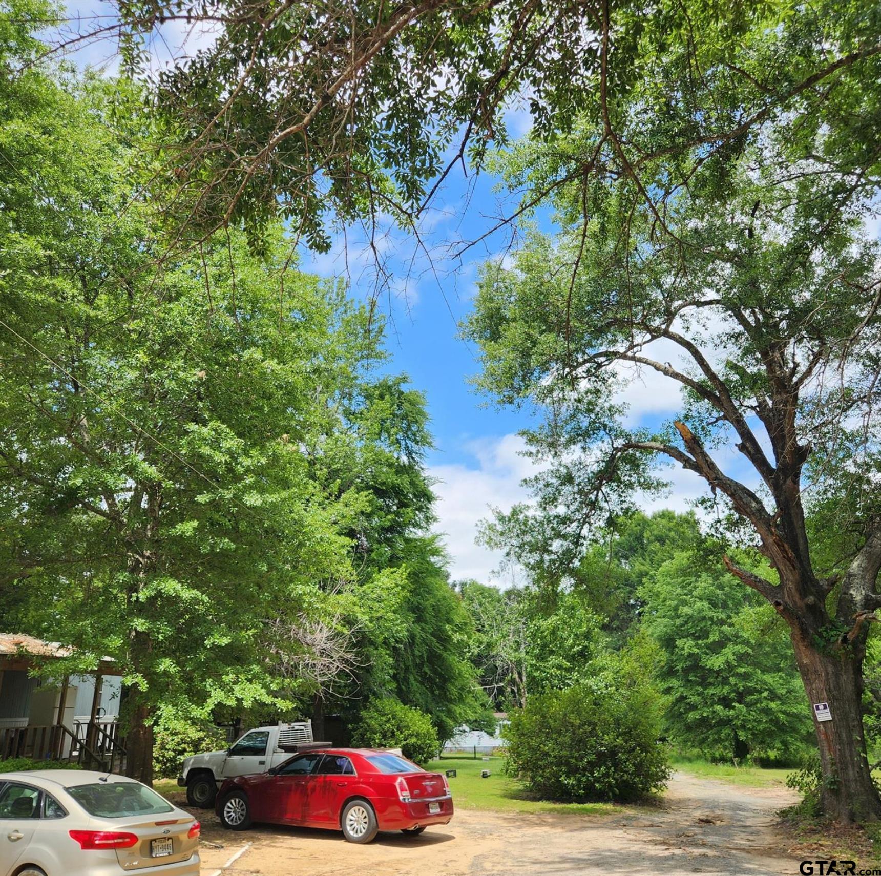 109 Falcon Spur Carthage, TX 75633 - Photo 5 of 13 a view of street with parked cars