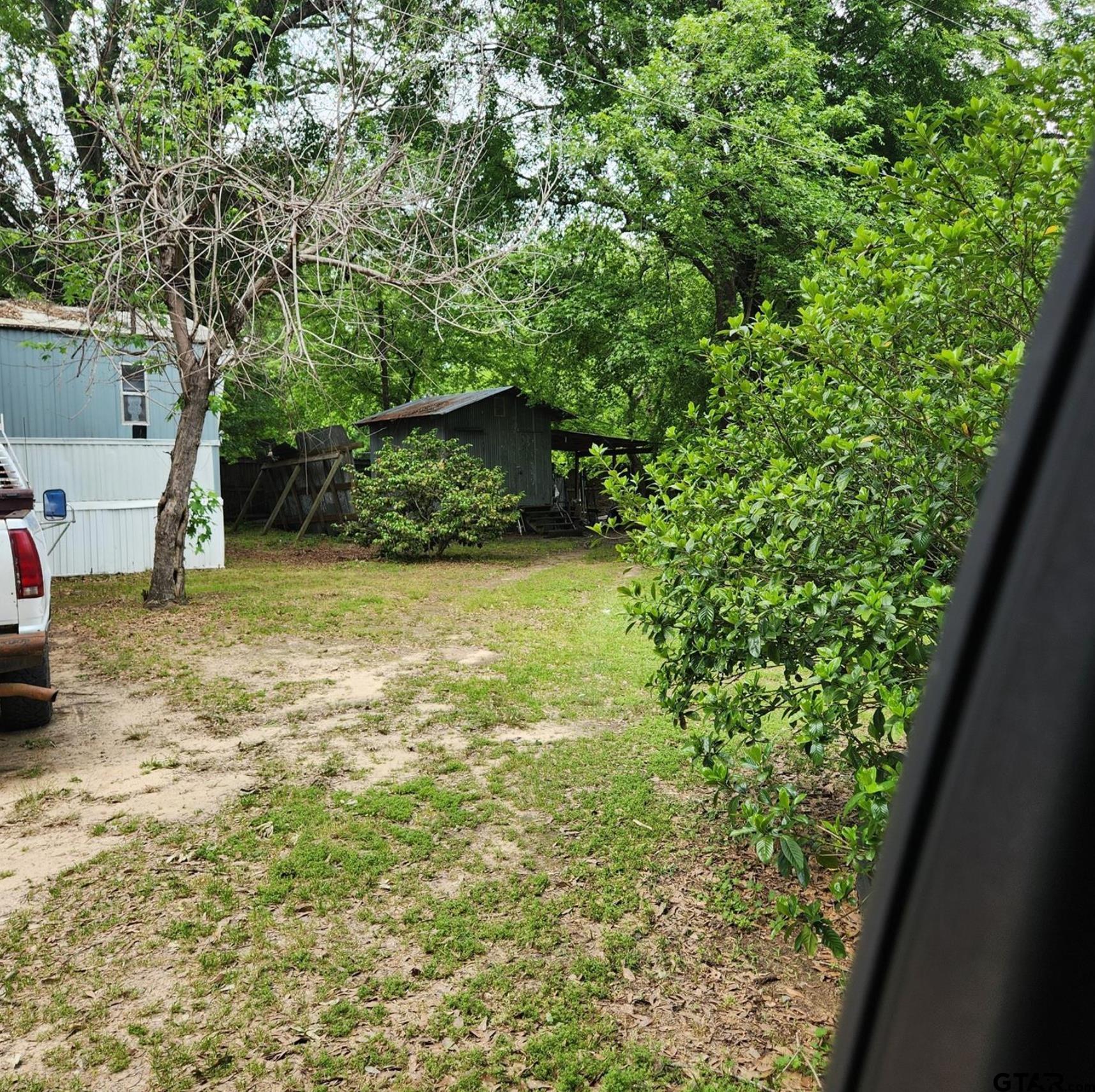 109 Falcon Spur Carthage, TX 75633 - Photo 6 of 13 a view of a yard with an outdoor space