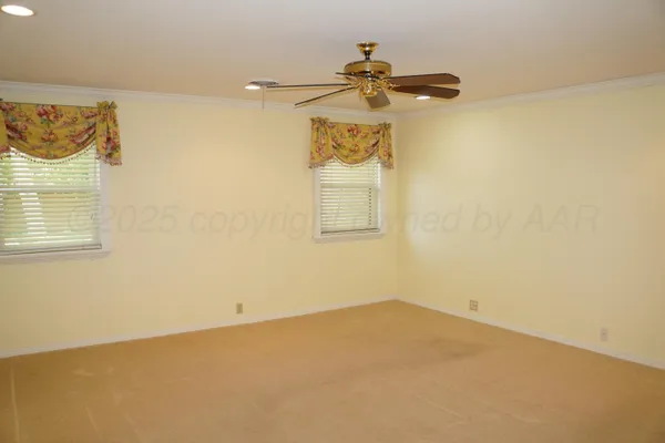 an empty room with a fan and a fan