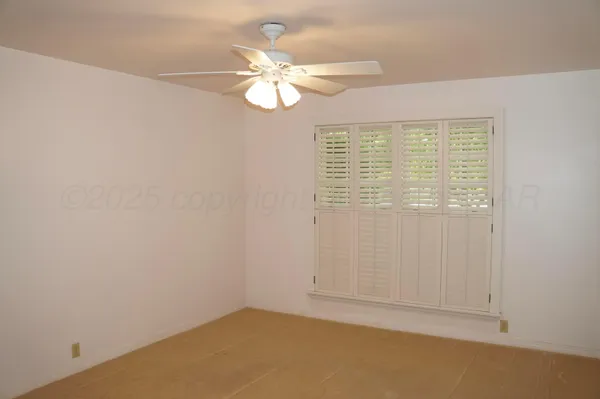 an empty room with wooden floor