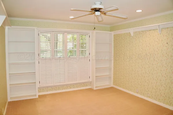 a bathroom with a light fixture and a chandelier fan