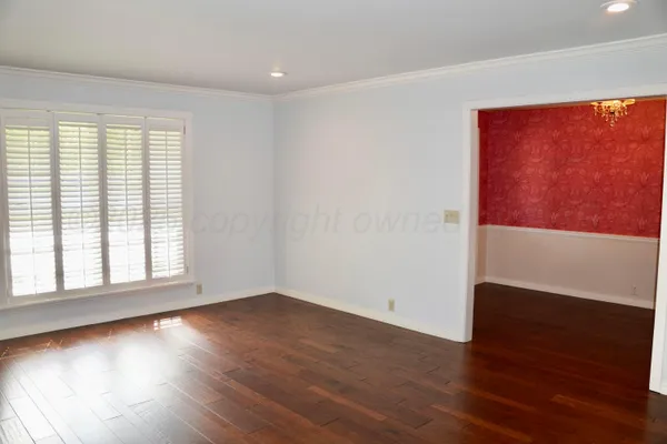 view of a room with wooden floor and entryway