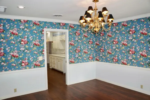 a kitchen with stainless steel appliances granite countertop a refrigerator a stove and a wooden floors