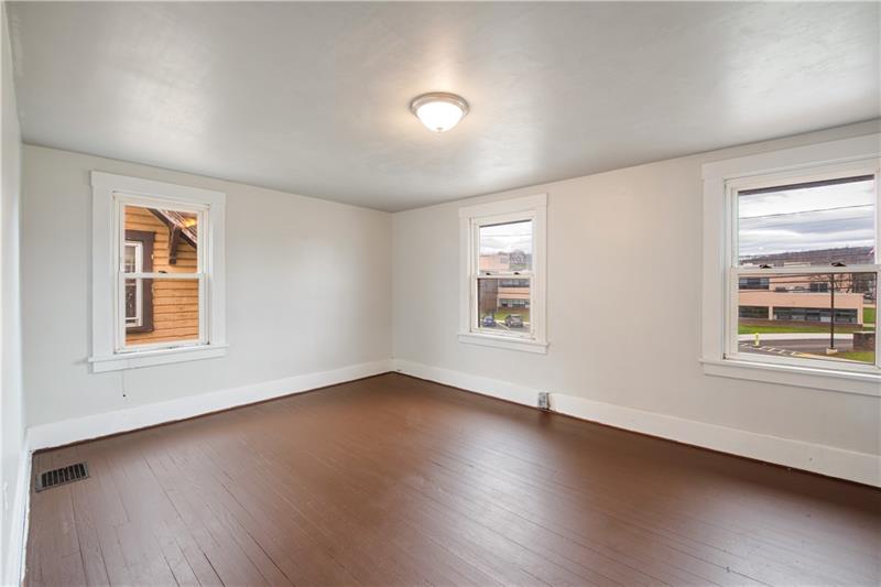 414 Virginia Avenue Rochester, PA 15074 - Photo 11 of 22 an empty room with wooden floor and windows
