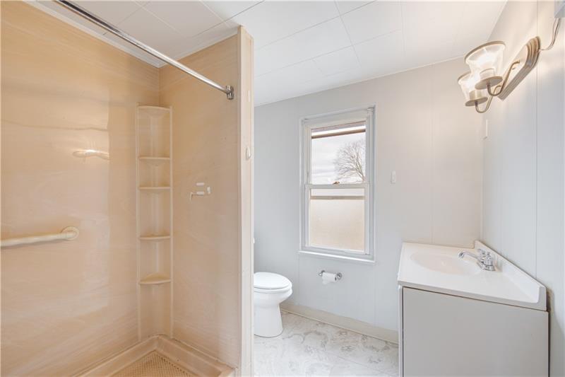 414 Virginia Avenue Rochester, PA 15074 - Photo 17 of 22 a bathroom with a granite countertop sink a toilet and shower