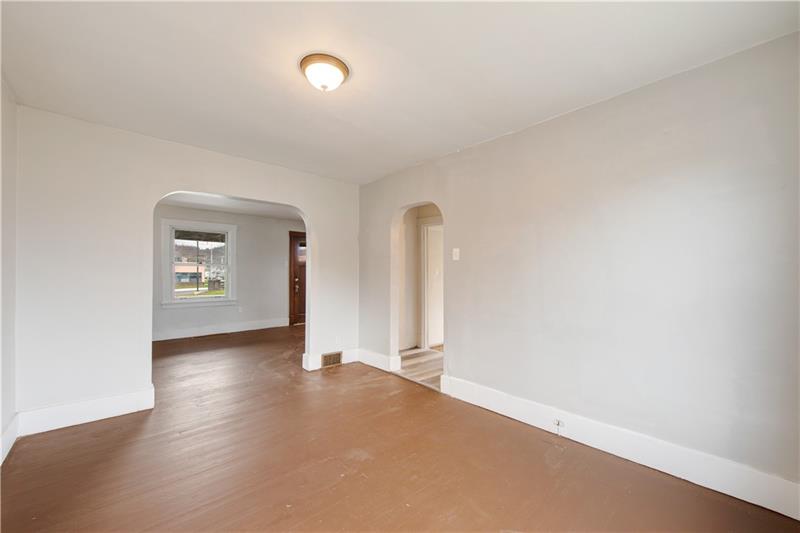 414 Virginia Avenue Rochester, PA 15074 - Photo 5 of 22 an empty room with wooden floor and mirror