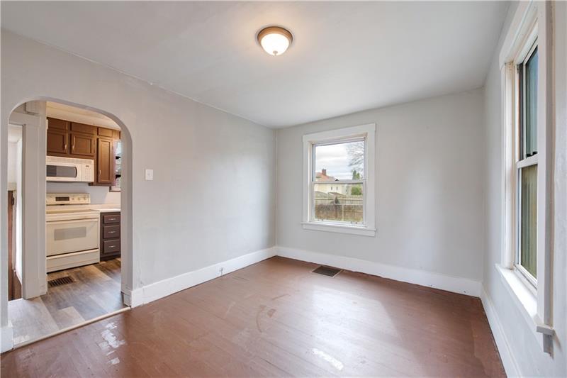 414 Virginia Avenue Rochester, PA 15074 - Photo 7 of 22 wooden floor in an empty room with a window