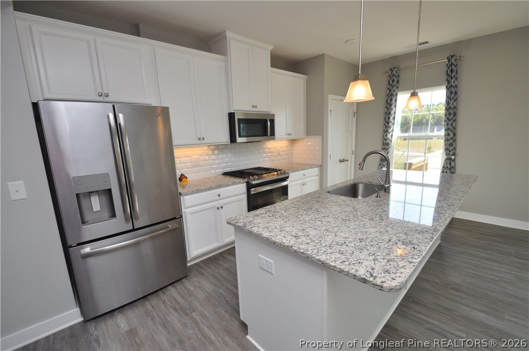 200 Misty Pike Drive Raleigh, NC 27603 - Photo 12 of 49 a kitchen with stainless steel appliances granite countertop a refrigerator a stove top oven a sink and dishwasher