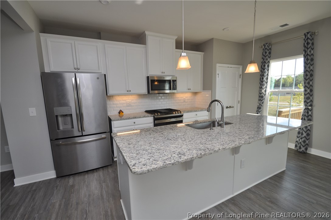 200 Misty Pike Drive Raleigh, NC 27603 - Photo 13 of 49 a kitchen with stainless steel appliances granite countertop a refrigerator a stove a sink and a refrigerator
