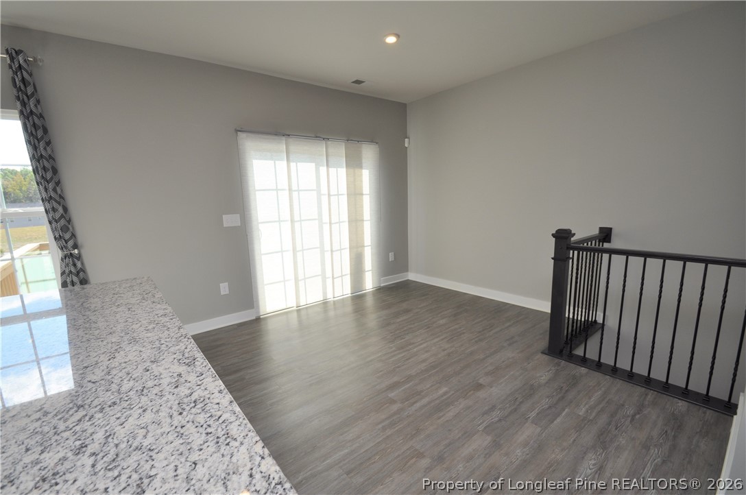 200 Misty Pike Drive Raleigh, NC 27603 - Photo 16 of 49 an empty room with wooden floor and windows