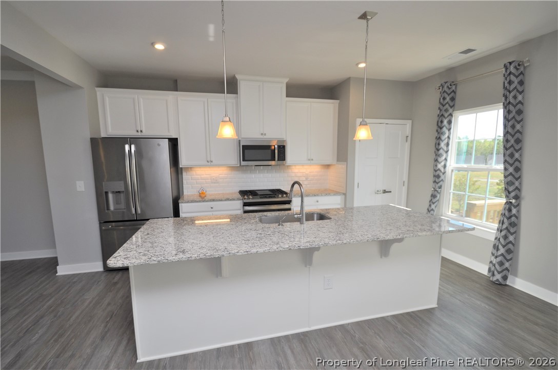 200 Misty Pike Drive Raleigh, NC 27603 - Photo 2 of 49 a large kitchen with kitchen island a large counter top stainless steel appliances and cabinets