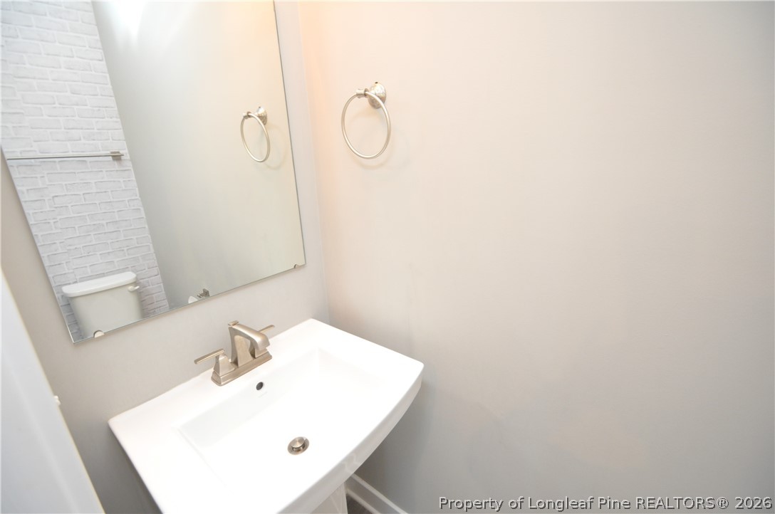 200 Misty Pike Drive Raleigh, NC 27603 - Photo 23 of 49 a bathroom with a sink a mirror and vanity