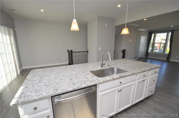 a kitchen with stainless steel appliances granite countertop a refrigerator a stove a sink and a refrigerator